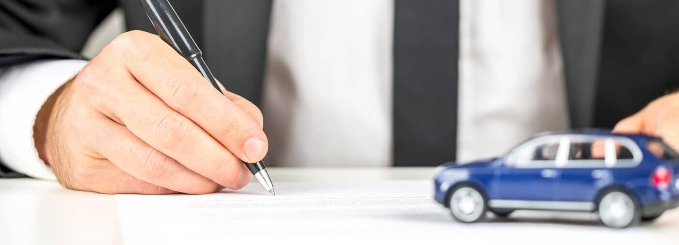 Dealership Finance Professional signing documents