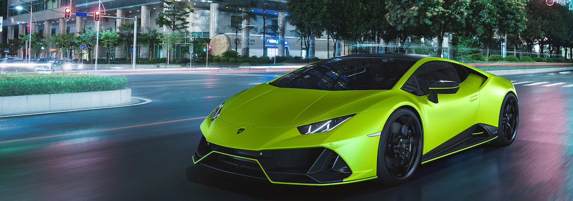 Neon Green 2021 Lamborghini Huracan driving on city street